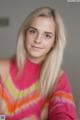 A young woman with long blonde hair posing for a picture.