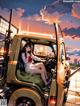 A woman sitting in the driver's seat of a truck.